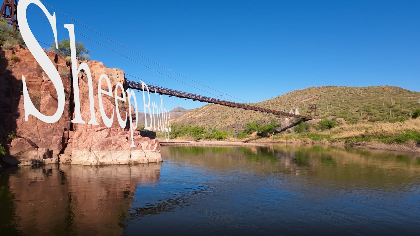 drone photo of a suspension bridge in the desert